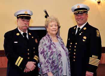 Pictured from left are acting Chief John Marsh, Mrs. Patricia Moriarty and Chief Brian Moriarty.