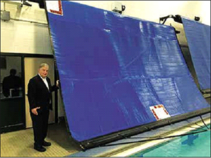 Mayor Fiorentini in front of the new energy saving high school pool cover.