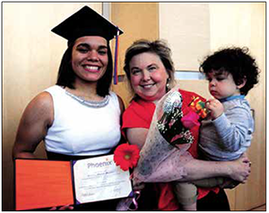 Destiny Morton with Beth E. Anderson, chief executive officer of Phoenix Academy Charter Network on her graduation day June 10, 2015. A total of 11 students acquired a high school diploma