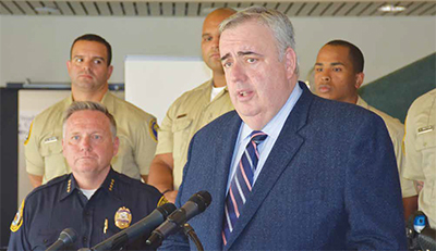 Former Boston Police Commissioner Ed Davis, at the mic, and Police Chief James Fitzpatrick, during the press conference.