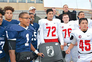 Some of the football players of Lawrence High School and Central Catholic High School were invited to participate at the unveiling. Standing behind them from left, Andy Jimenez, father of Alex Jimenez; John MacDonald of The National Veterans Foundation and Council Vice-president Marc Laplante.